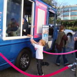A child being served ice cream from an Ice Scream Social ice cream truck at a product launch event in Boston